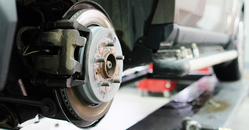 Brake pads installed on a caliper, on a disc braking system